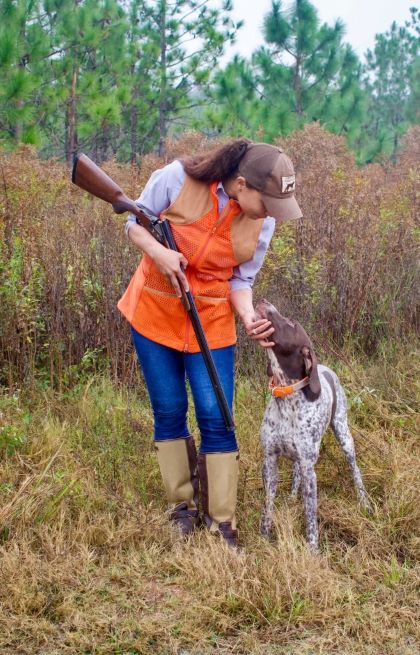 Manda looking down at dog respectfully
