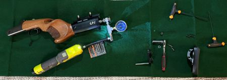 A Scientific Quest for Zero Recoil Leads a Physicist to Silicon Valley’s Grip+ 13 Filling the Grip+ piston through its Schrader valve using a no-leak fill system and a Ryobi cordless air pump. Because the piston volume is very small, even a brief loss of air while disconnecting a standard pump can drop the pressure below the desired setting. The no-leak Schrader valve tool helps prevent that pressure loss, but the butt plate must be removed to provide enough access for the fitting.