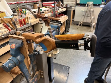 A Scientific Quest for Zero Recoil Leads a Physicist to Silicon Valley’s Grip+ 8 The Grip+ stock clamped during final fitting, with the piston-based recoil system visible behind the custom grip and adjustable comb. The piston changes how recoil is delivered to the shooter by spreading the force over a longer impulse, reducing the sharpness of the kick and helping the gun recover more smoothly between shots.